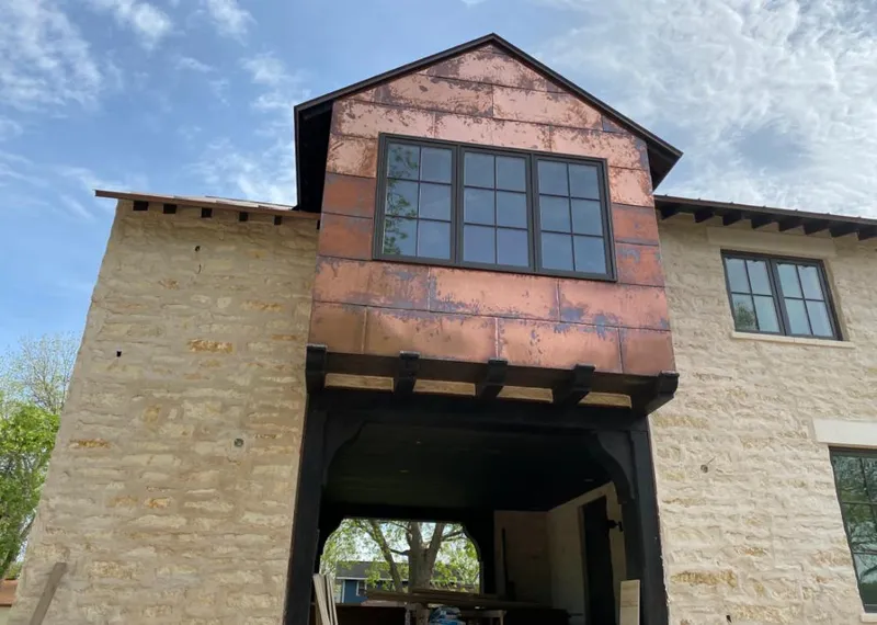 Copper metal panel facade on a stone building for Skylight Installation in Newport News